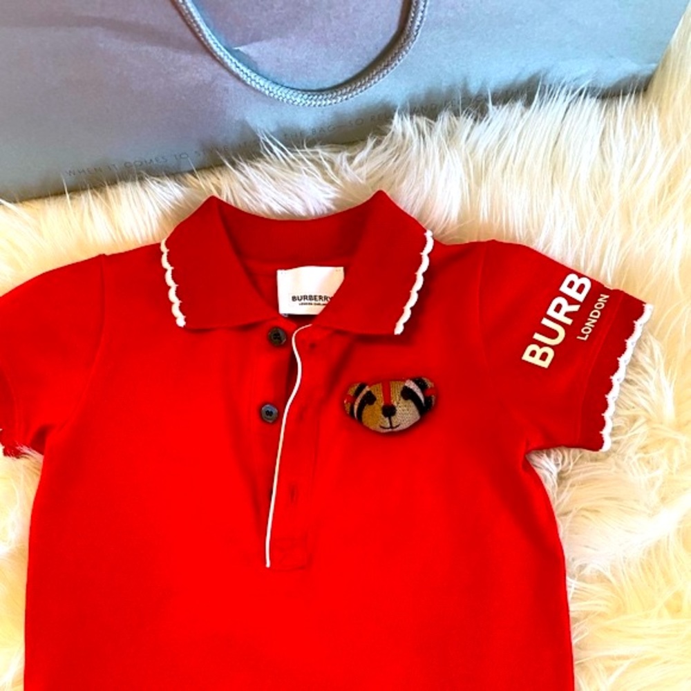Adorable authentic onsie. Burberry Thomas the Bear displayed  on front